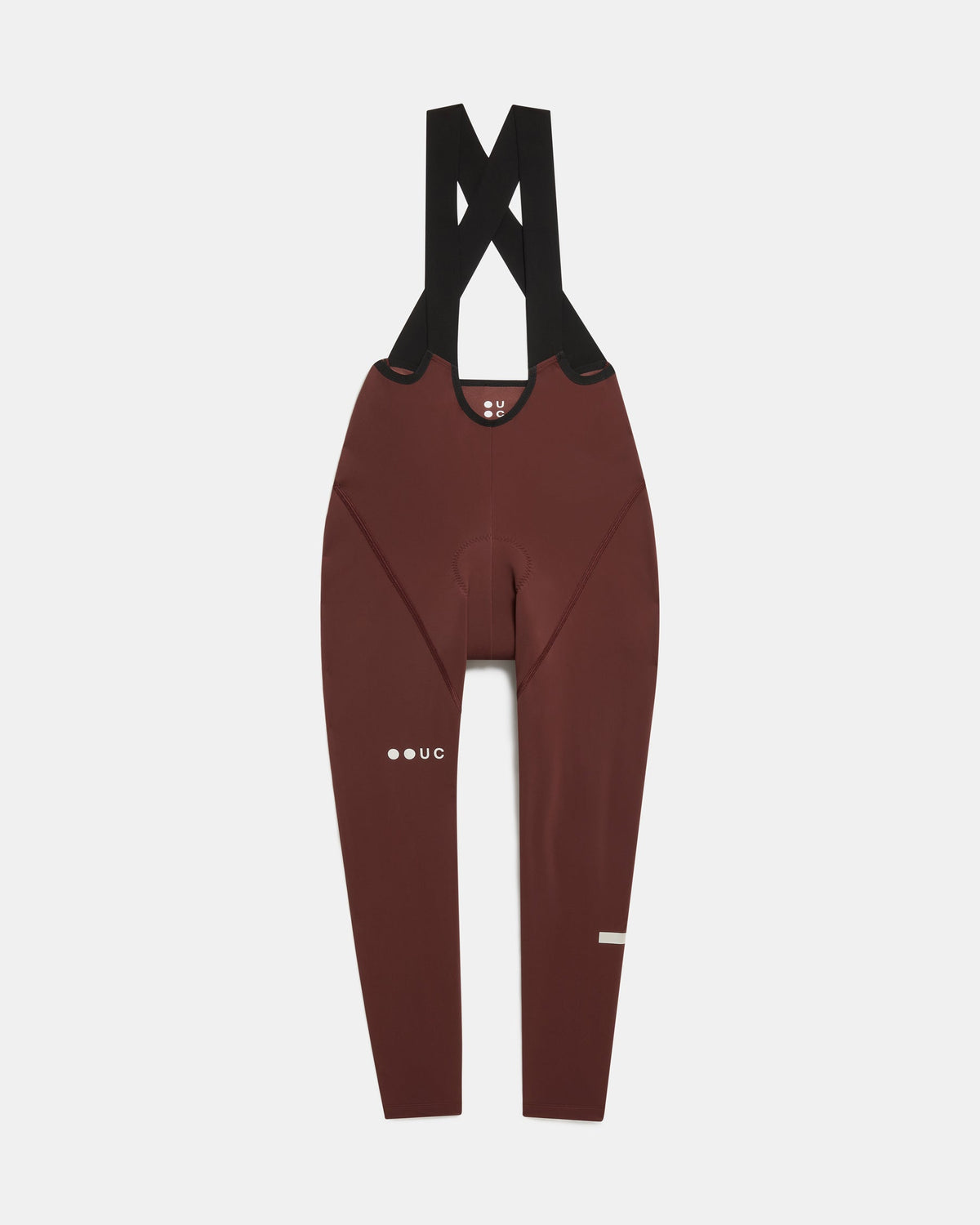 Flatlay of the Women's Mono Bib Tight in Deep Red: crossed shoulder straps, integrated chamois and UC logo on the thigh.