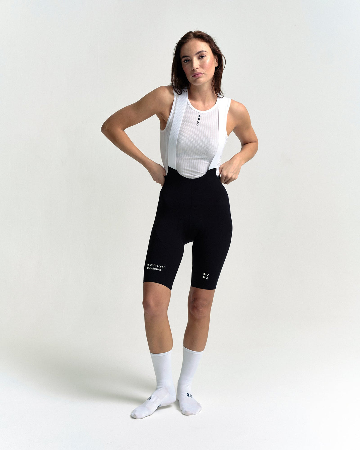 Model in the Women's Chroma Cargo Bib Shorts in Black, full-length view.