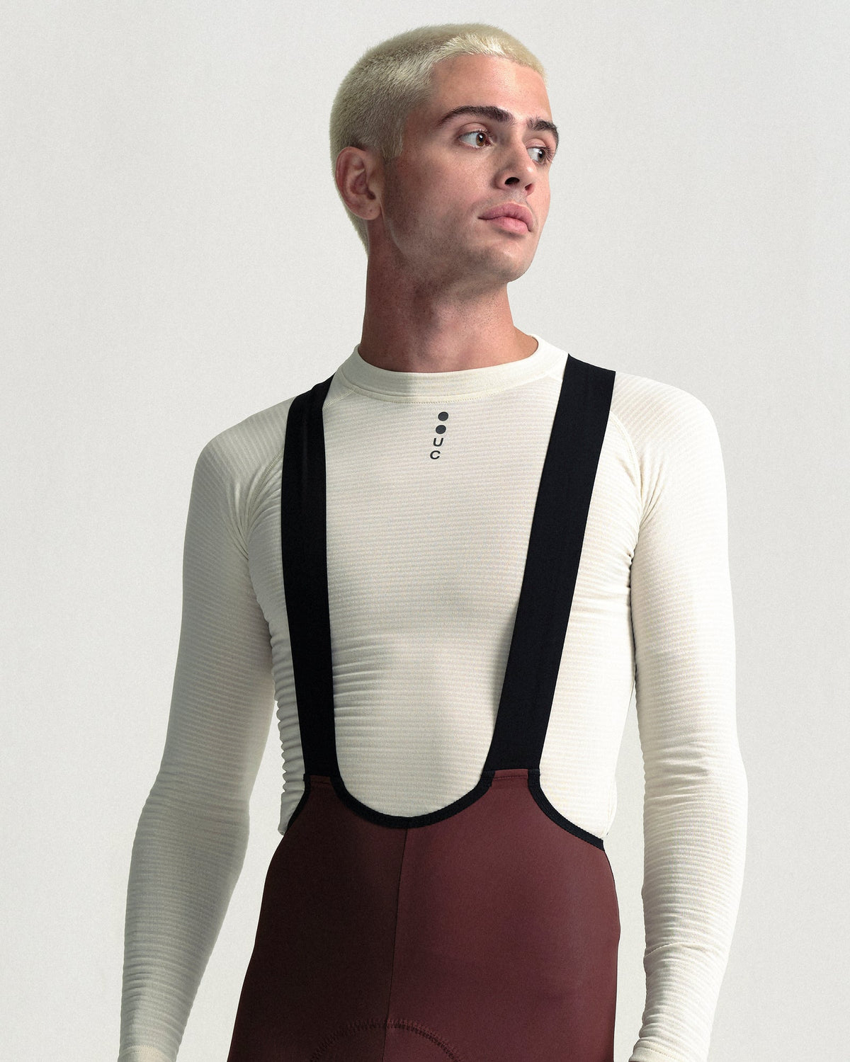 Model wearing the Men's Mono Bib Tight in Deep Red.