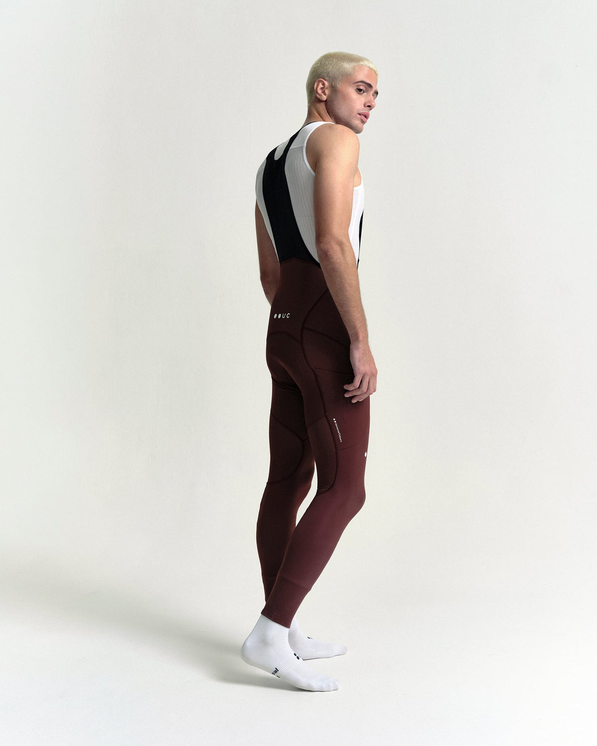 Model wearing the Men's Mono Cargo Bib Tight in Deep Red.
