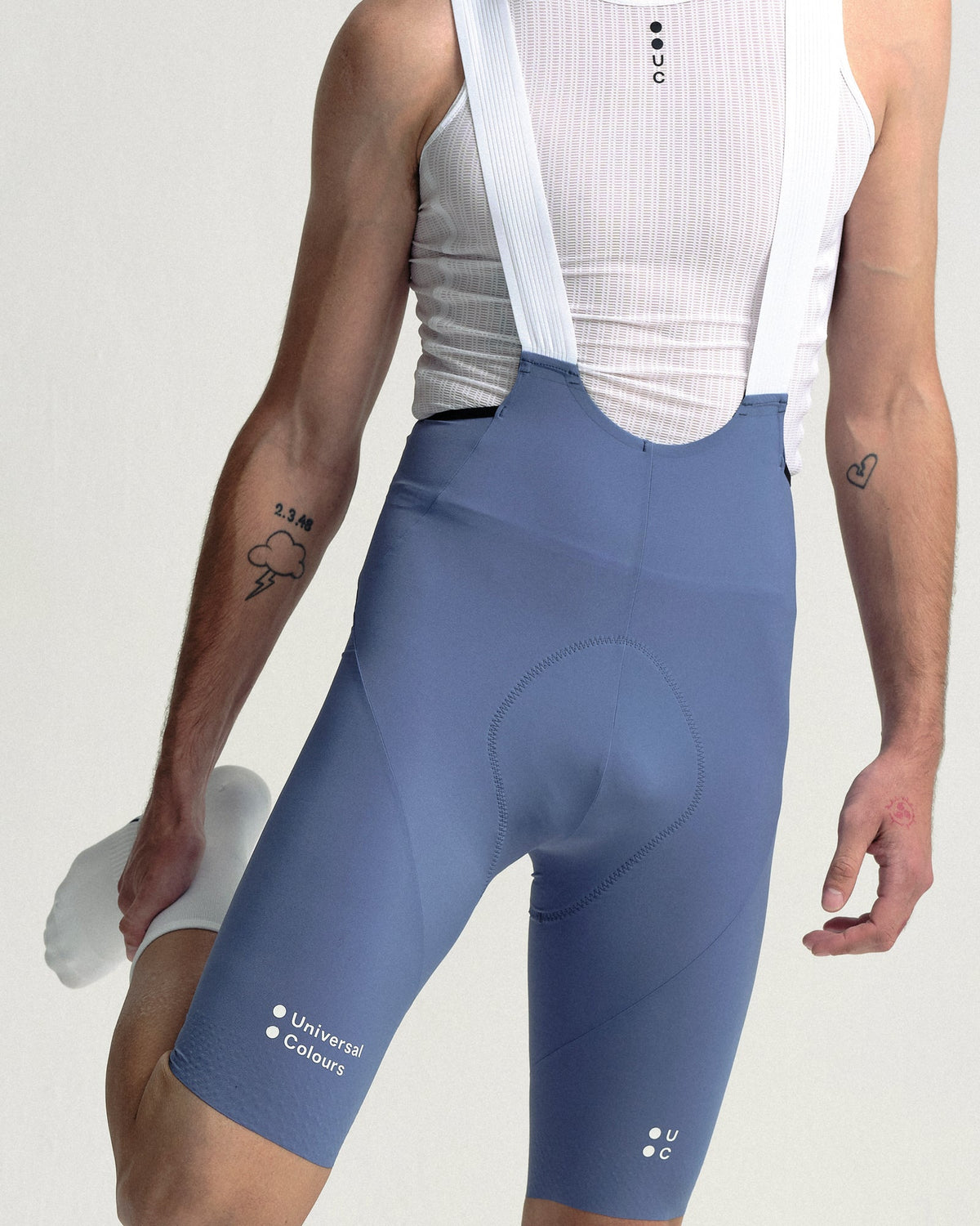 Close view of the Men's Chroma Bib Shorts in Slate Blue: chamois, leg logos and mesh bib straps.