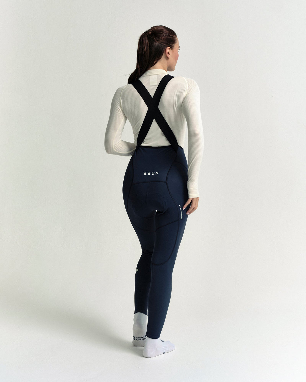 Model in the Women's Mono Bib Tight in Eclipse Navy, full-length view.