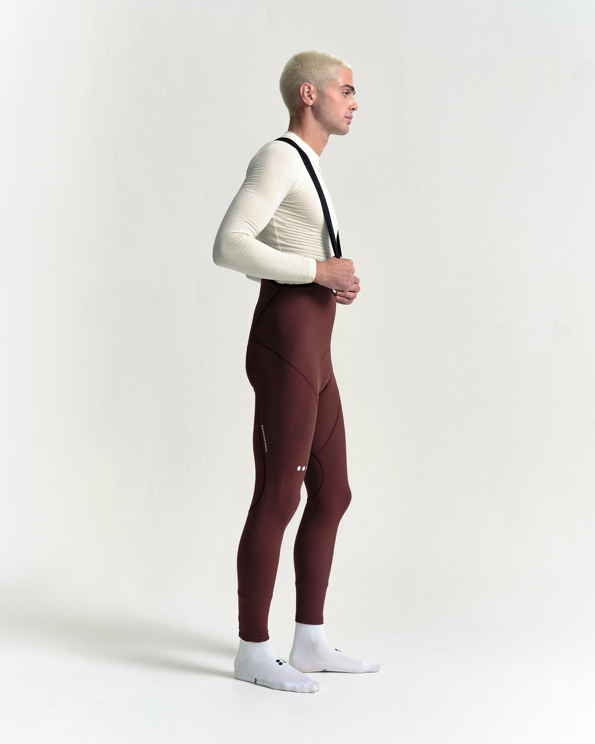 Model wearing the Men's Mono Bib Tight in Deep Red.