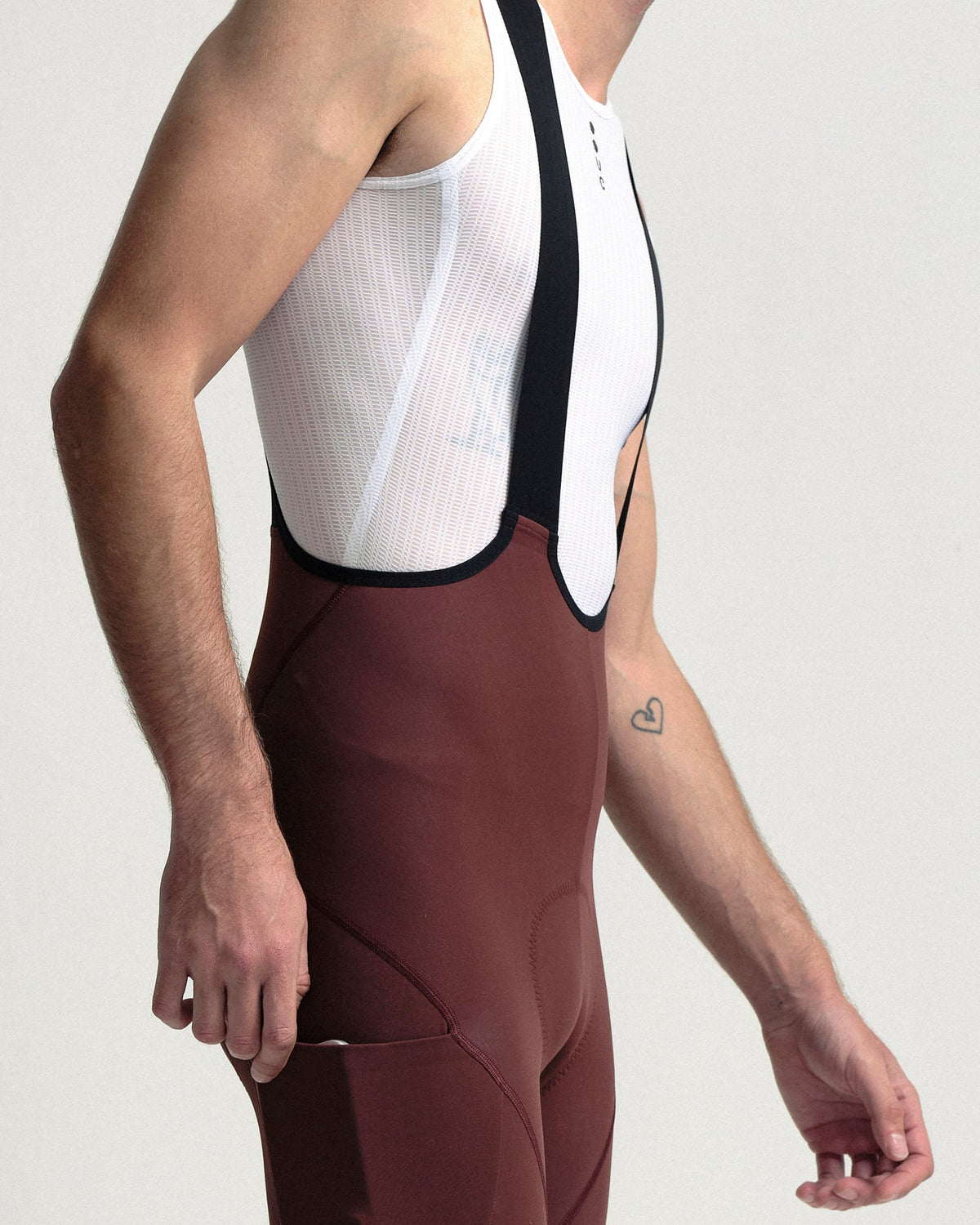 Model wearing the Men's Mono Cargo Bib Tight in Deep Red.