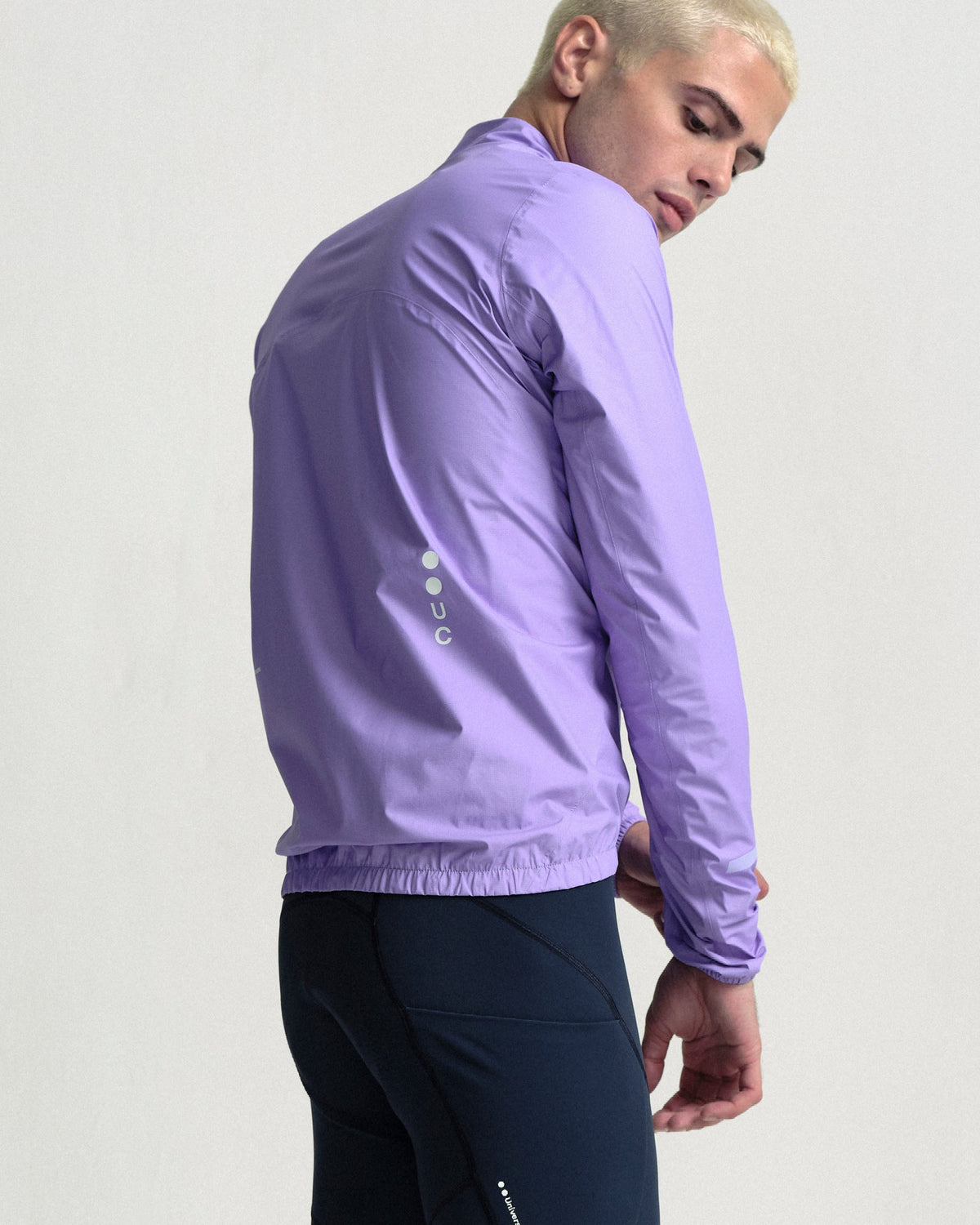 Model wearing the Men's Mono Rain Jacket in Cloud Lilac.