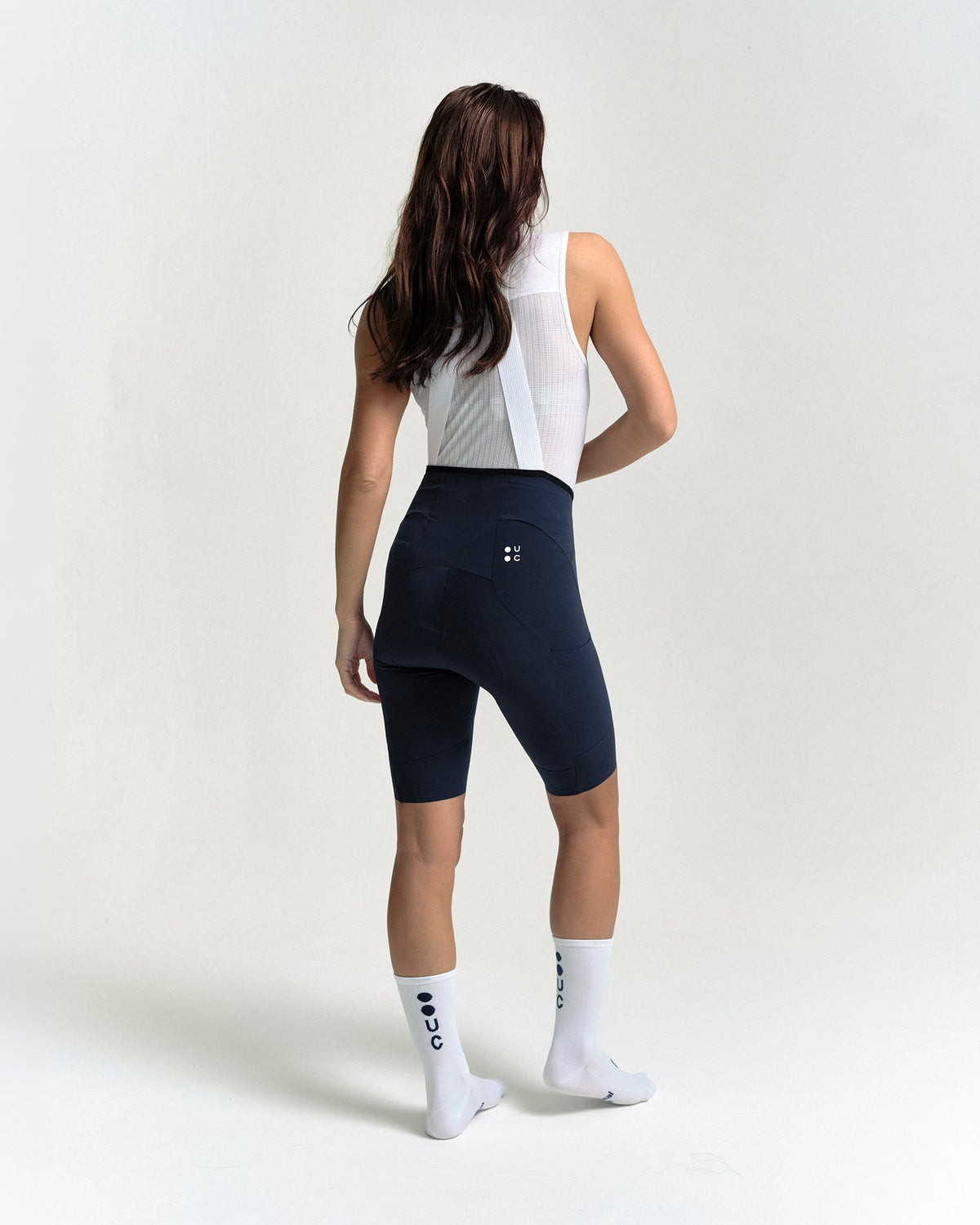 Model wearing the Women's Chroma Cargo Bib Shorts in Navy Blue.