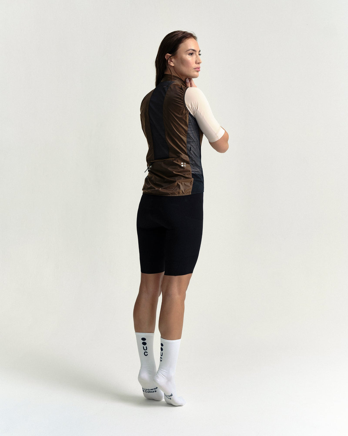 Model wearing the Women's Spectrum Gilet 2.0 in Honey Gold.