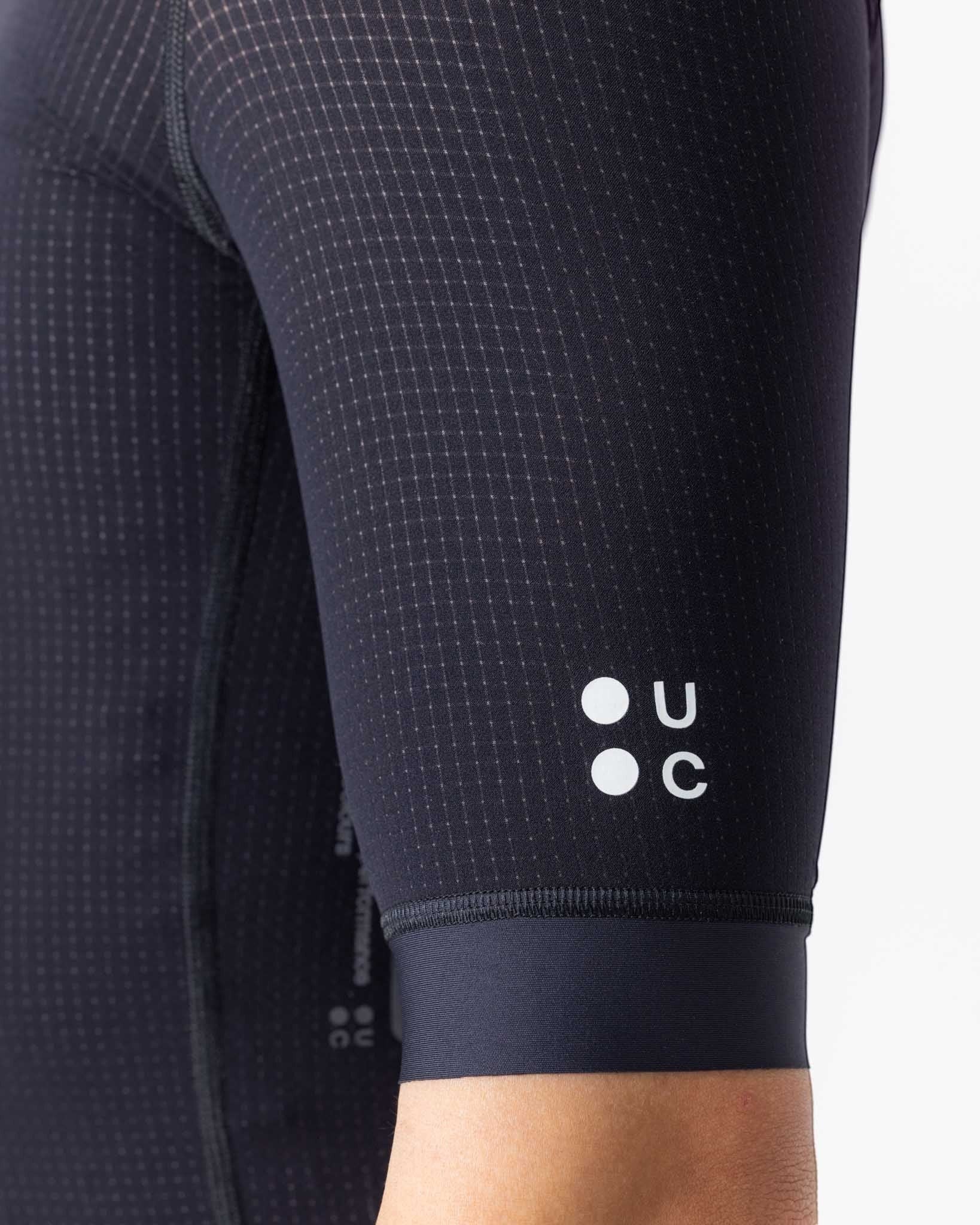 Moloko Cycling Ltd. black short sleeve cycling jersey made from French nylon with a subtle grid pattern and UC logo.