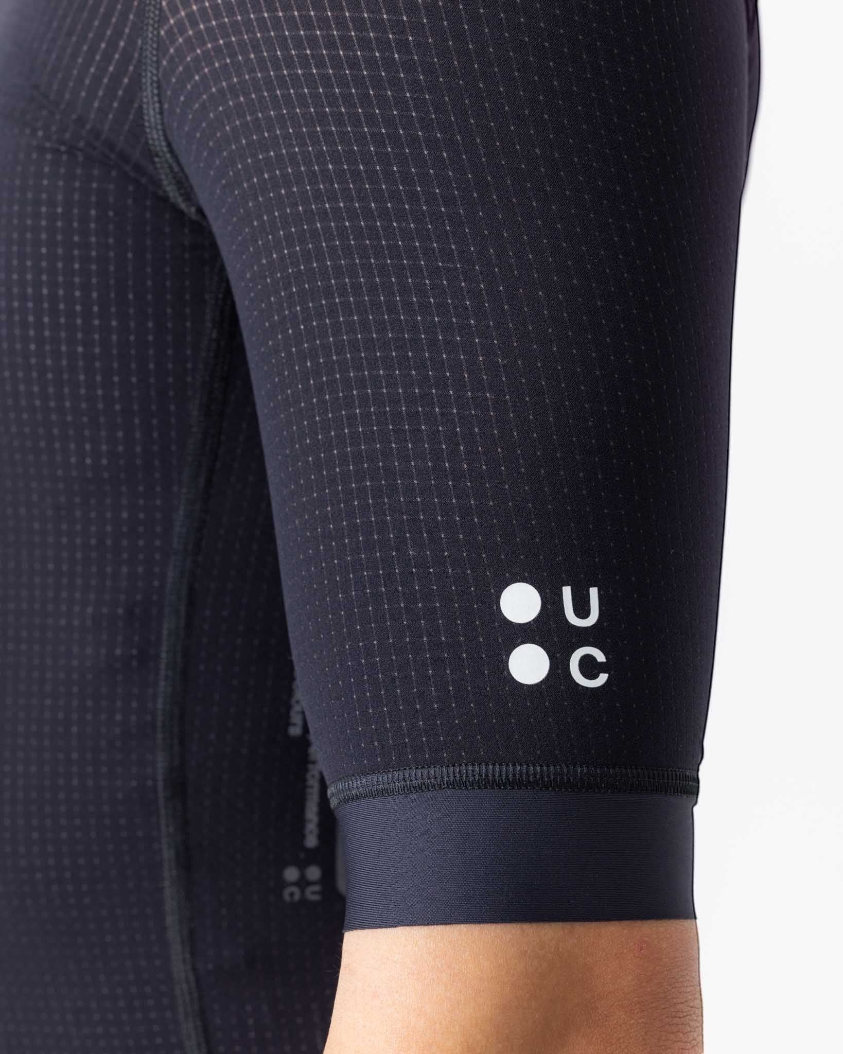 Moloko Cycling Ltd. black short sleeve cycling jersey made from French nylon with a subtle grid pattern and UC logo.