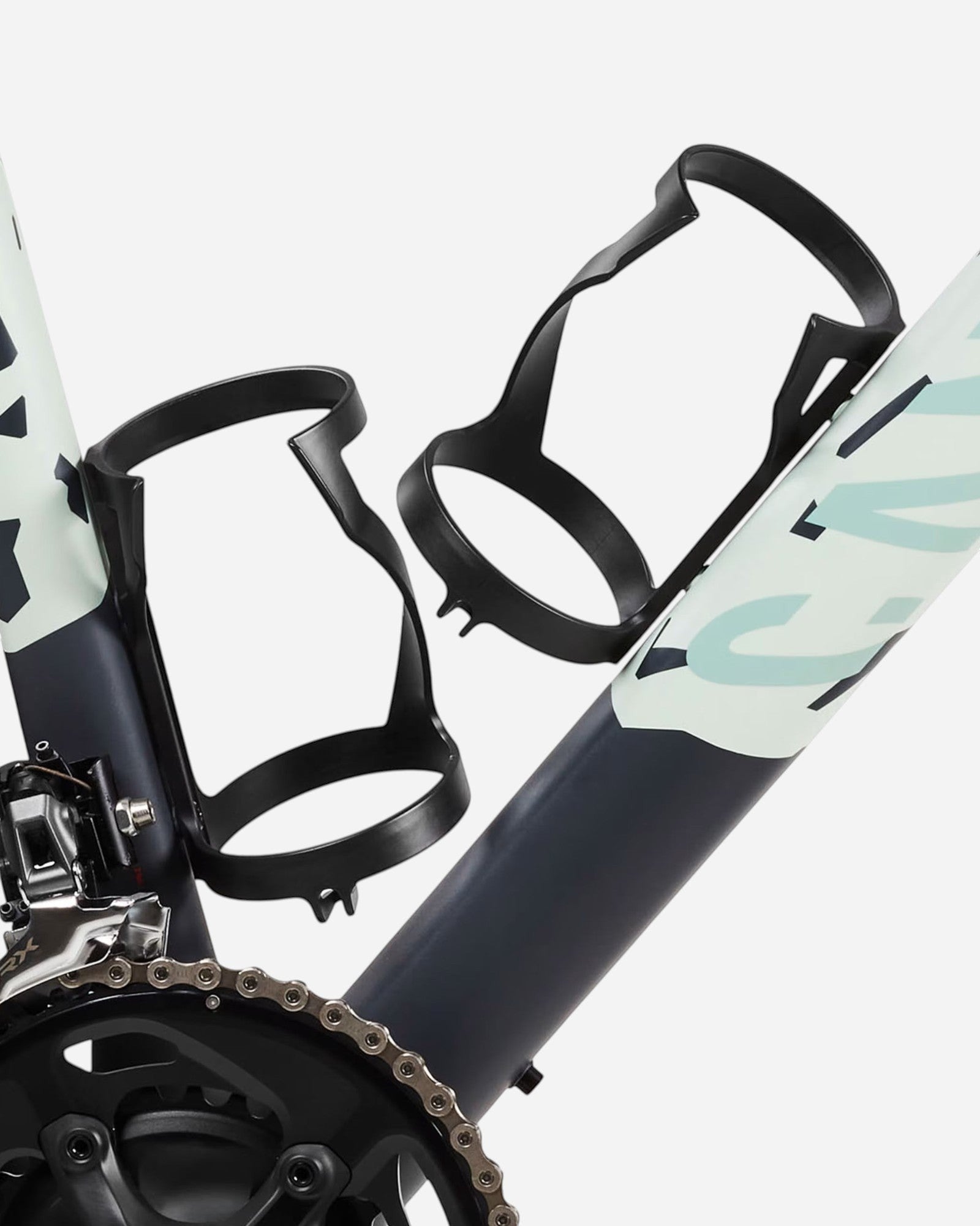 Moloko Cycling Ltd. carbon side-loading bottle cages mounted on a bicycle frame for easy access.