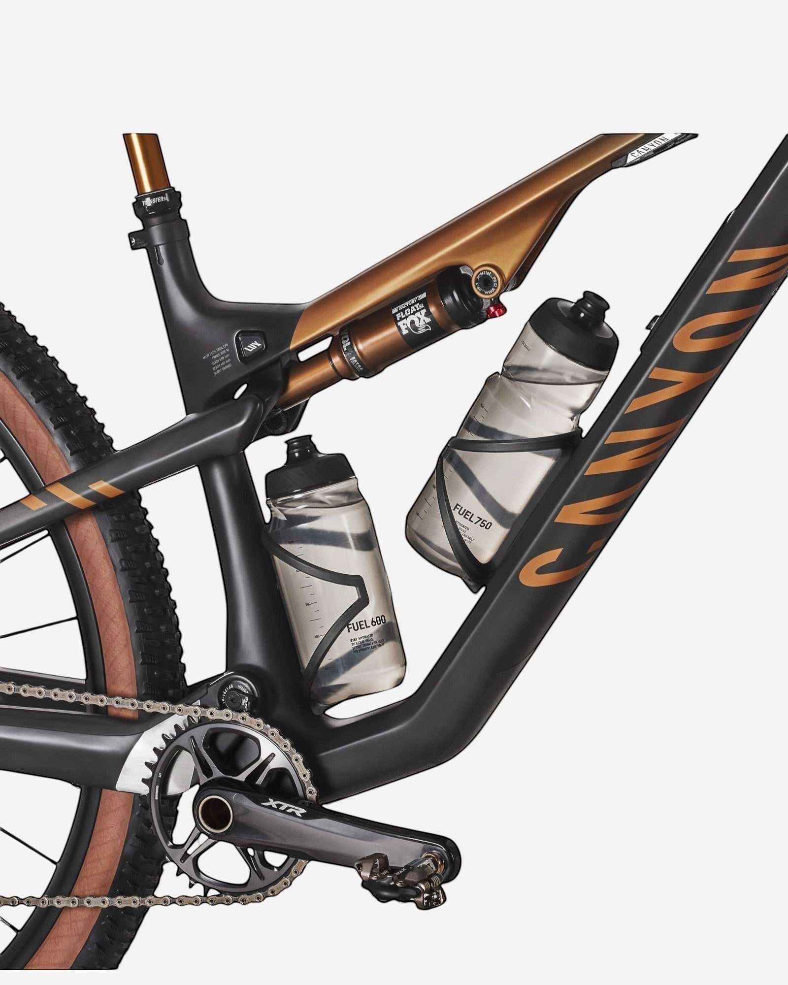 Moloko Cycling Ltd. Ex-Demo Lux Trail CFR 2024 M mountain bike, black carbon frame with bronze accents, dual water bottles, and Fox suspension.