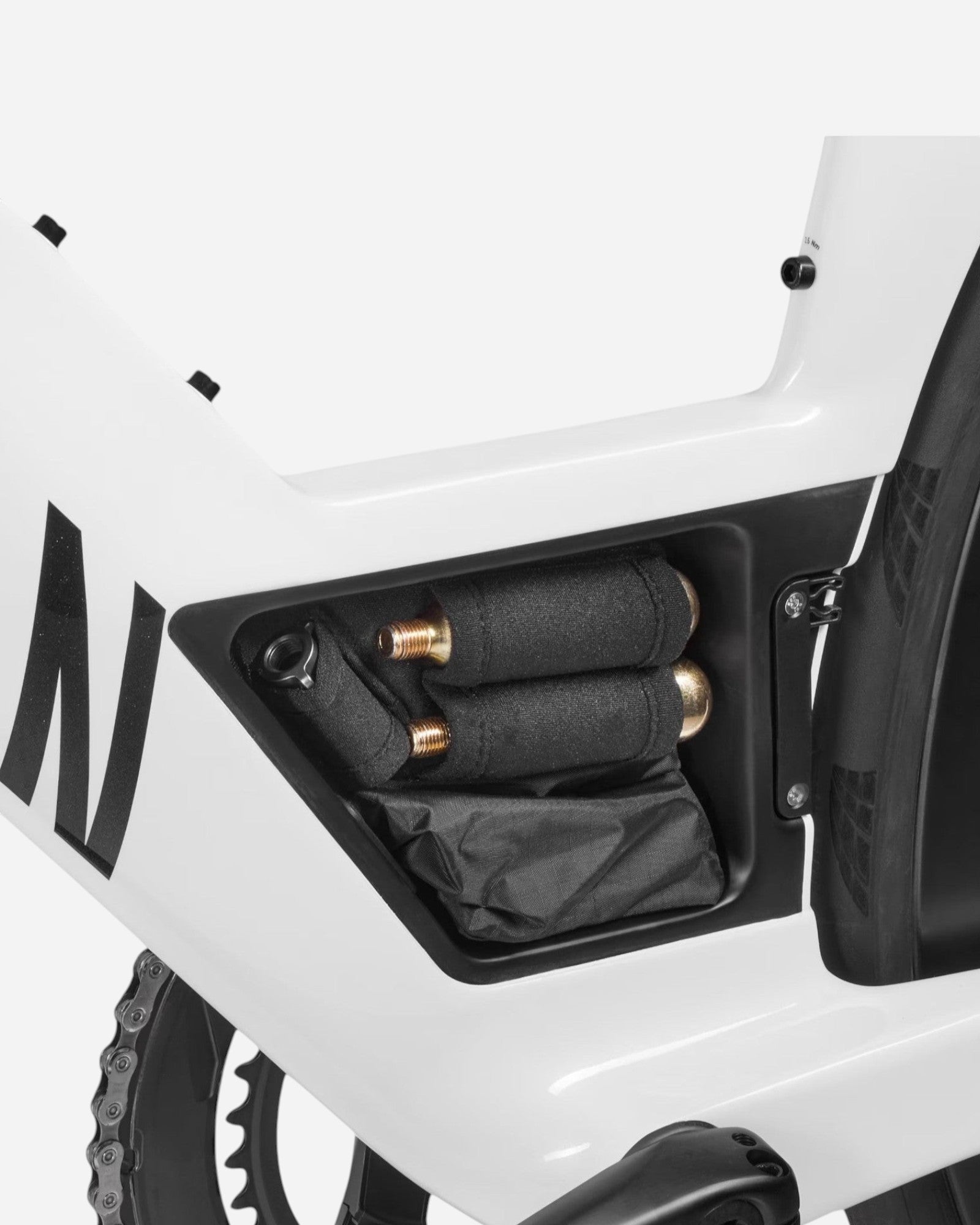 Moloko Cycling Ltd. white Speedmax CF SLX bike frame storage compartment with black chain and tools.