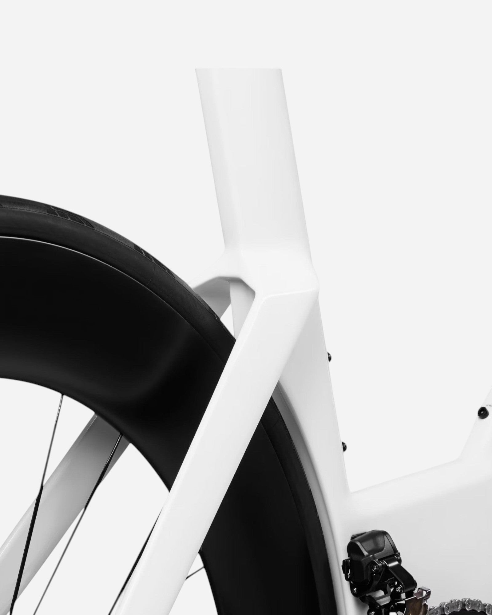 Moloko Cycling Ltd. white Speedmax CF SLX aerodynamic carbon fiber road bike frame detail with rear wheel and derailleur.