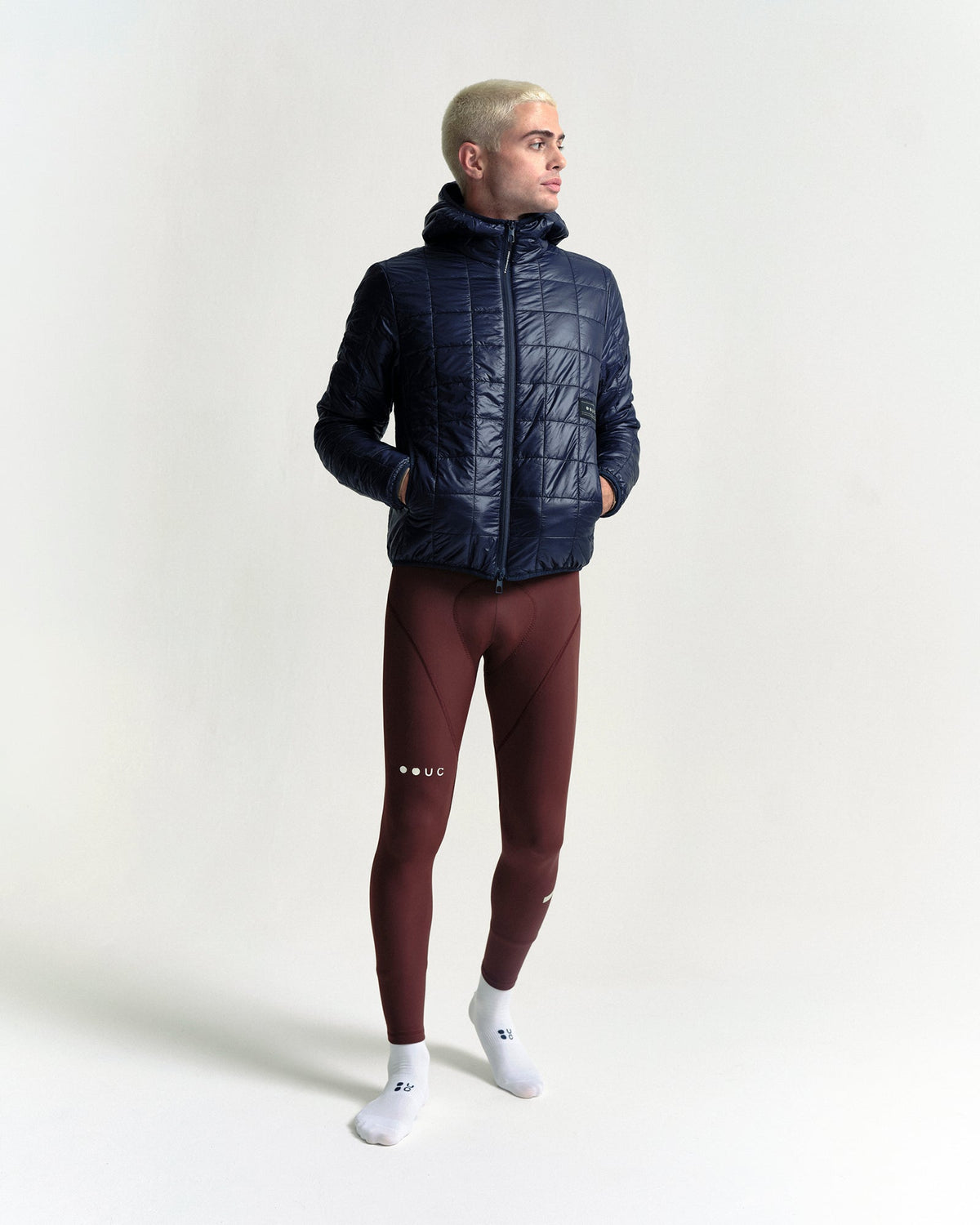 Model wearing the Unisex Insulated Packable Jacket in Ink Blue.