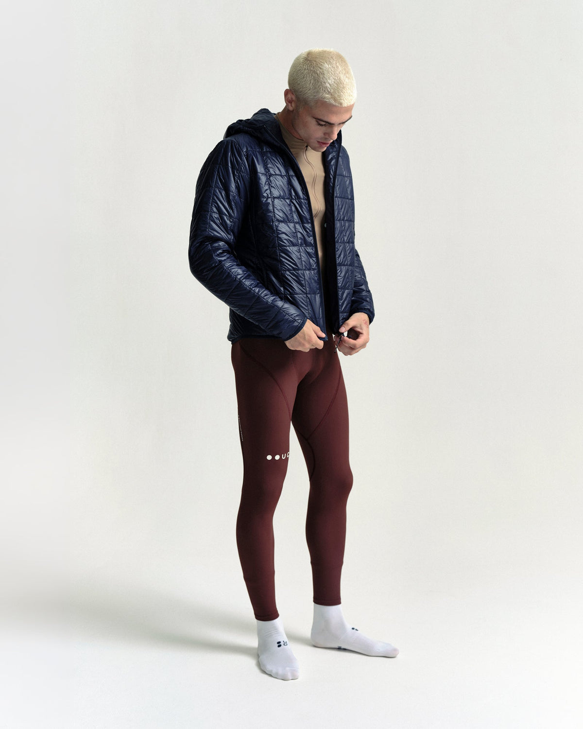 Model wearing the Unisex Insulated Packable Jacket in Ink Blue.