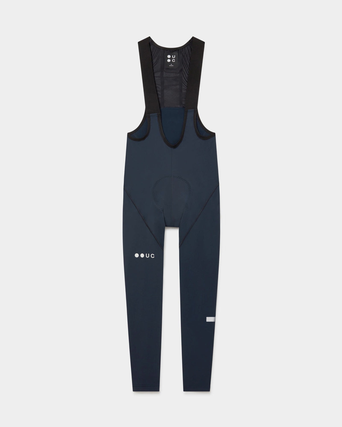 Flatlay of the Men's Mono Bib Tight in Eclipse Navy: mesh bib straps, contoured chamois and UC thigh logo.