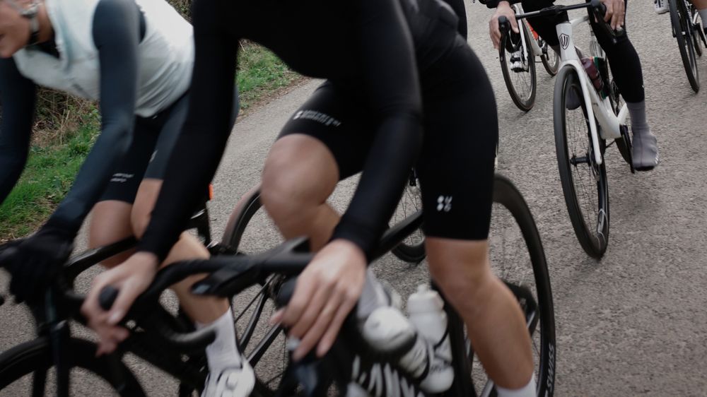 Riders in a tight group on a country lane