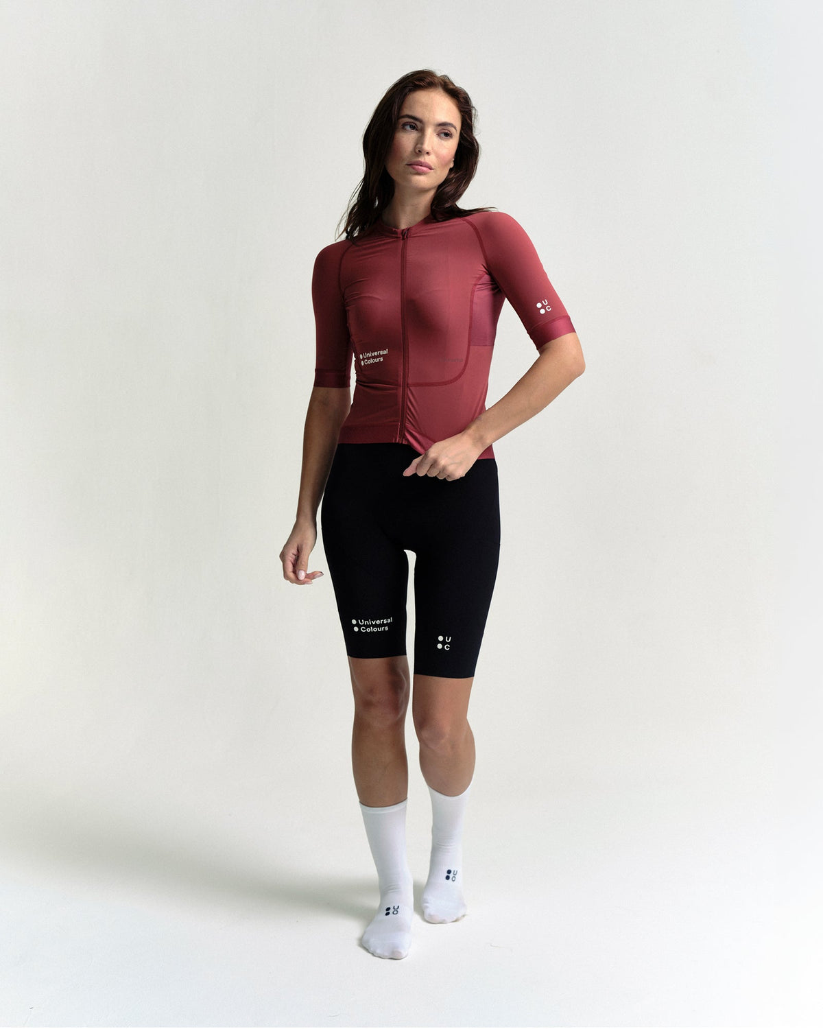 Model in the Women's Chroma Short Sleeve Jersey in Earth Red, full-length view.