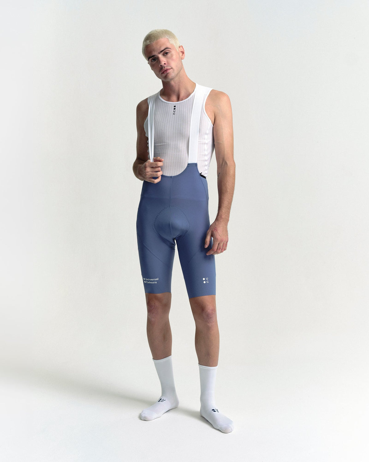 Model in the Men's Chroma Cargo Bib Shorts in Slate Blue, full-length view.