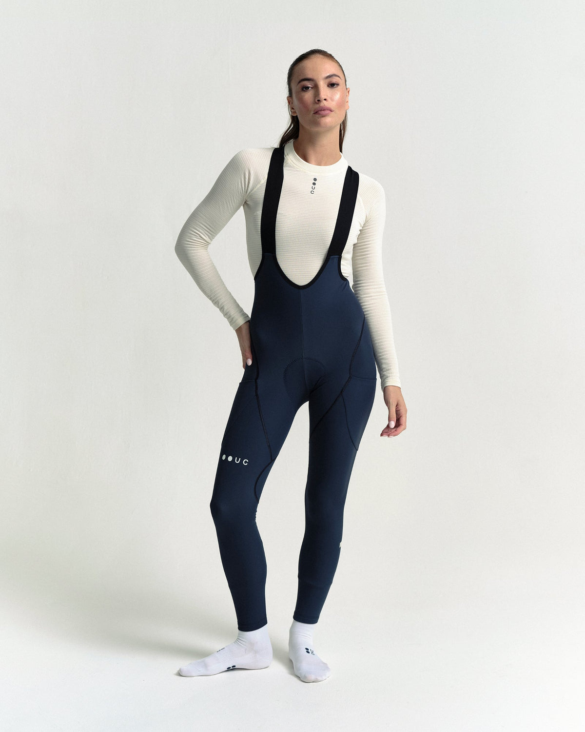 Model wearing the Women's Mono Cargo Bib Tight in Eclipse Navy.