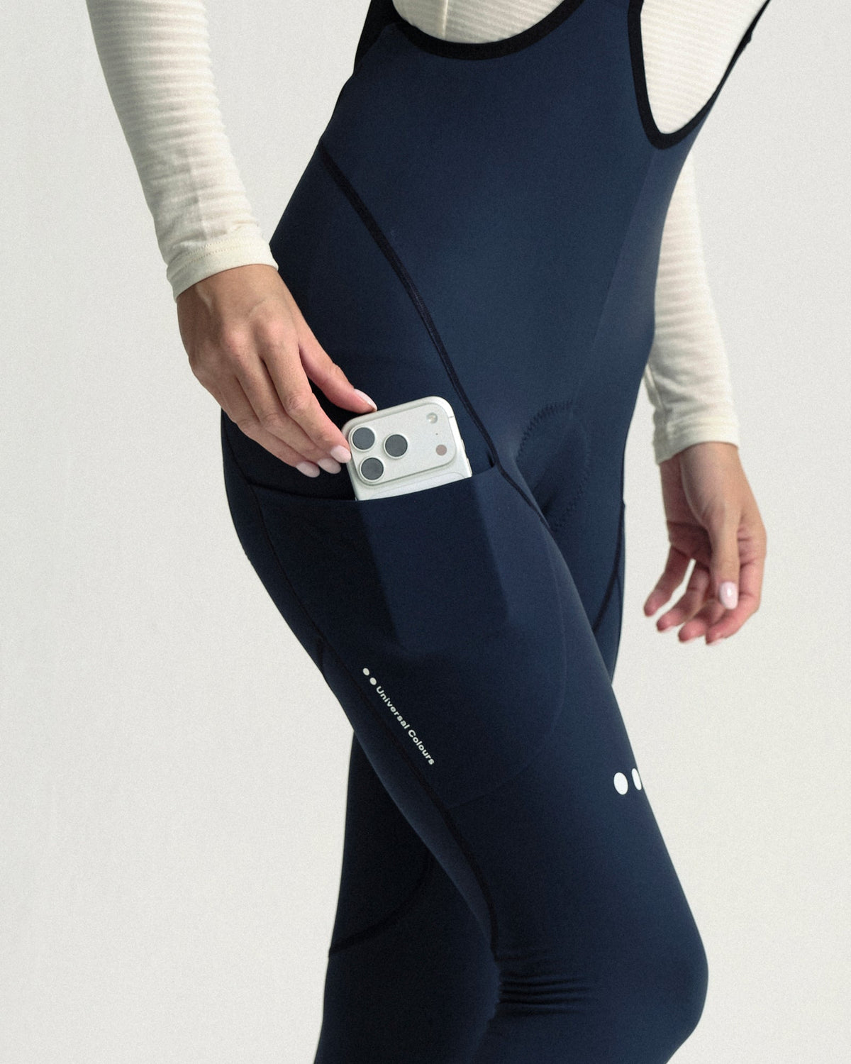 Model wearing the Women's Mono Cargo Bib Tight in Eclipse Navy.