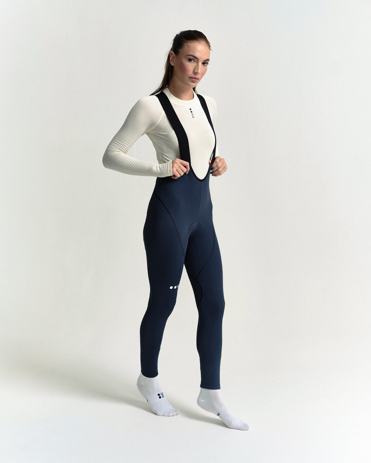 Model wearing the Women's Mono Bib Tight in Eclipse Navy.
