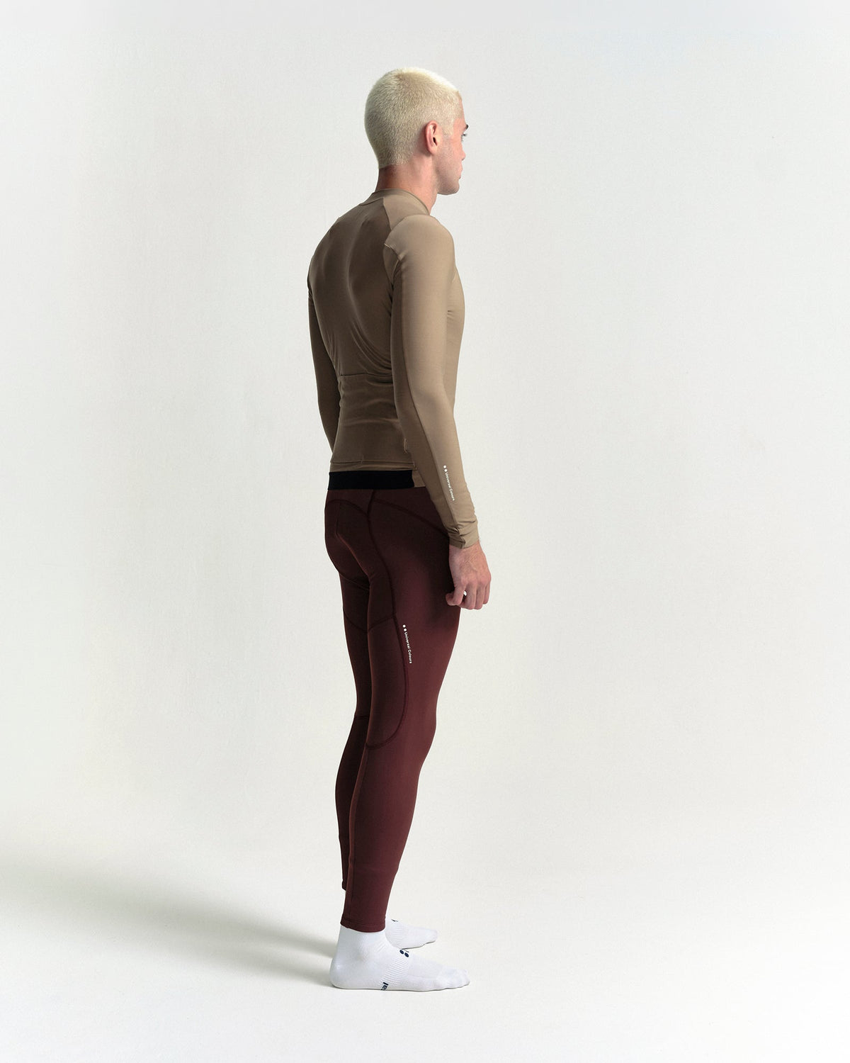 Model in the Men's Mono Long Sleeve Jersey in Walnut Brown, full-length view.