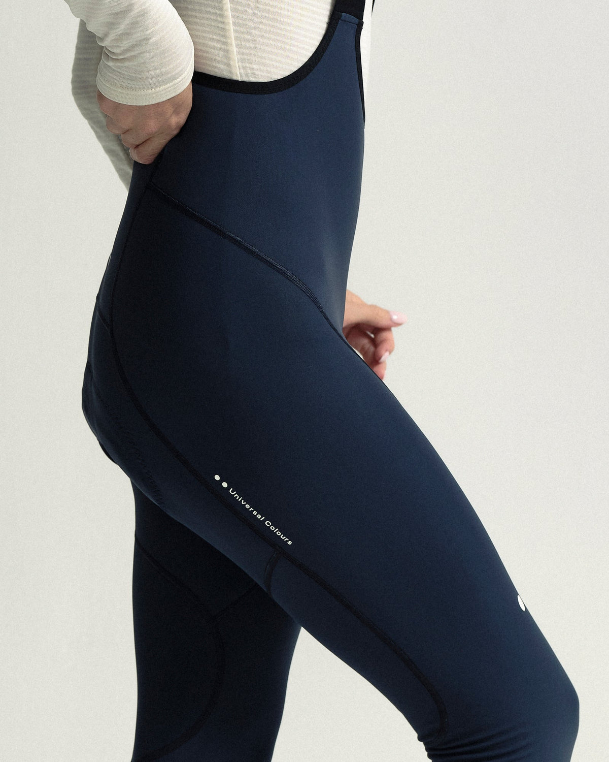 Model wearing the Women's Mono Bib Tight in Eclipse Navy.