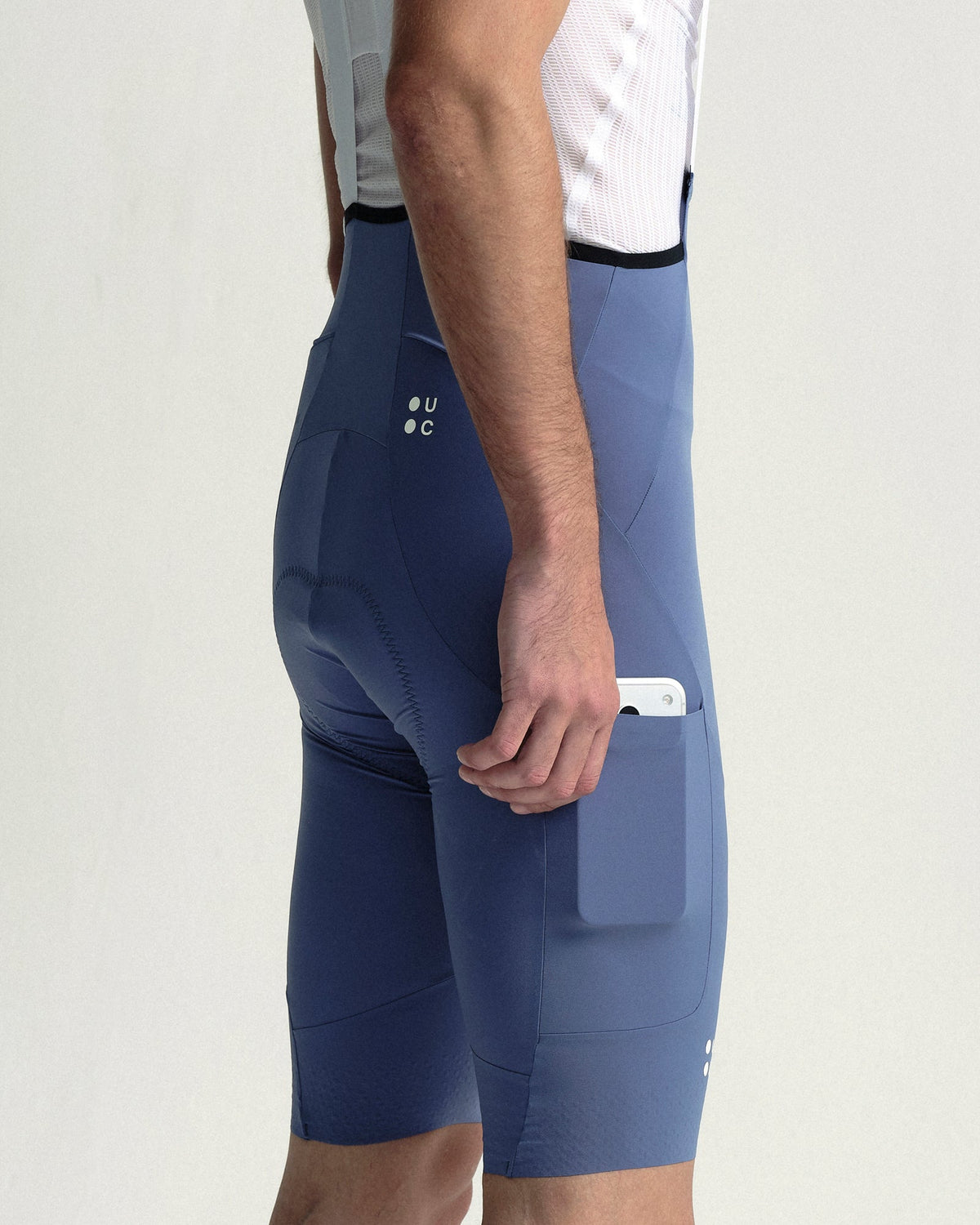 Model wearing the Men's Chroma Cargo Bib Shorts in Slate Blue.