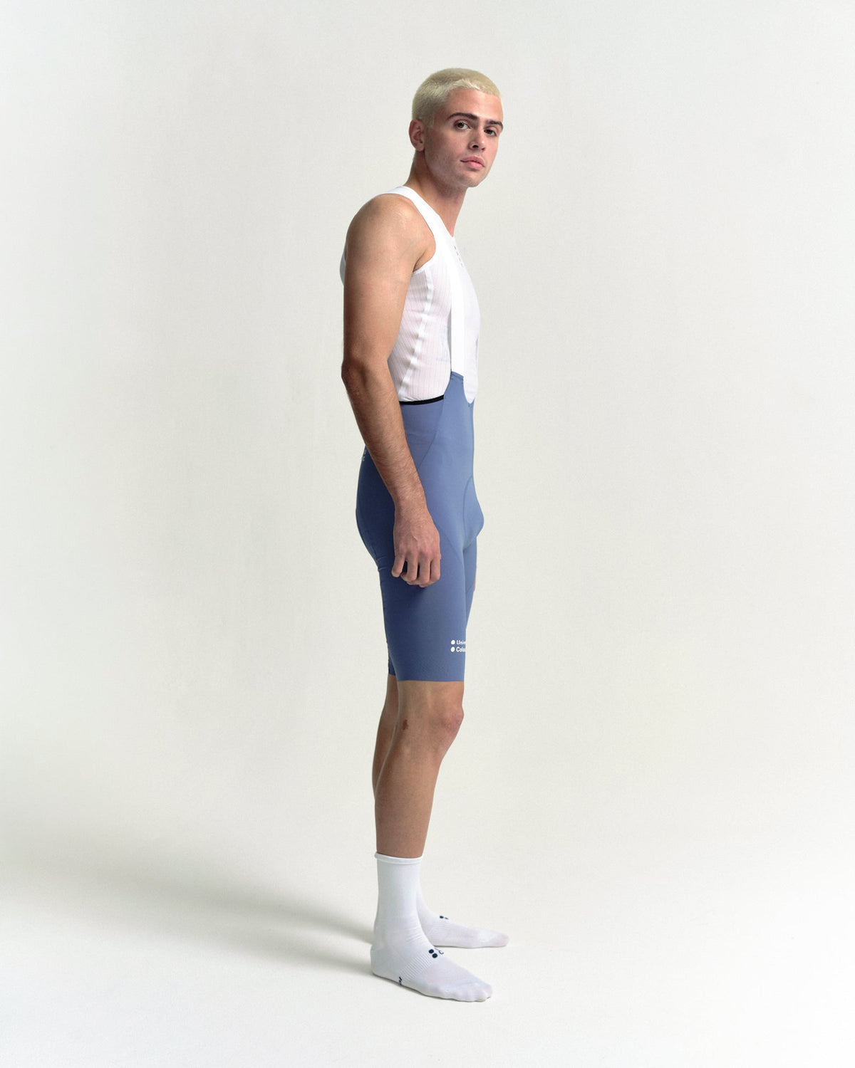 Model in the Men's Chroma Bib Shorts in Slate Blue, side view.