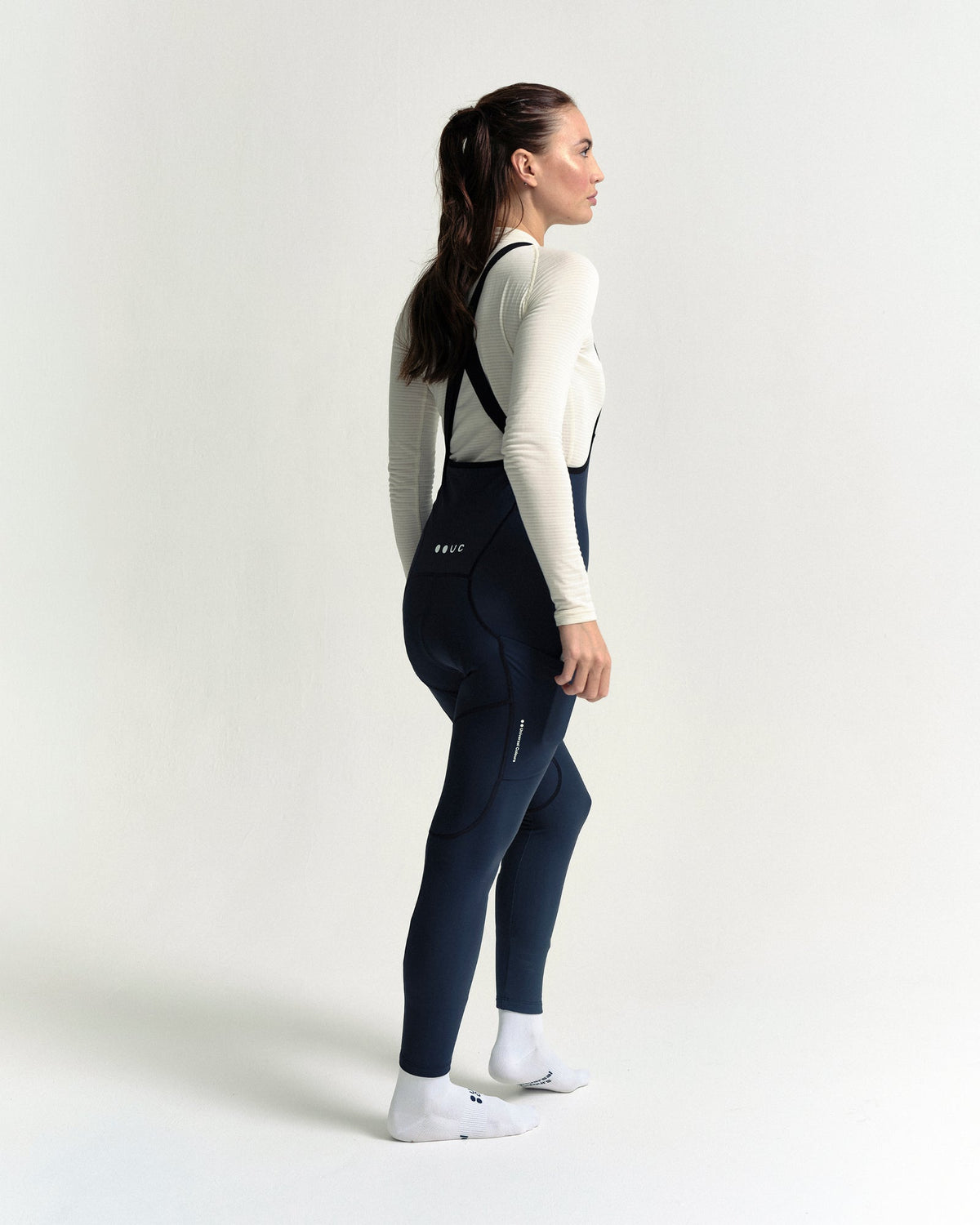 Model wearing the Women's Mono Cargo Bib Tight in Eclipse Navy.