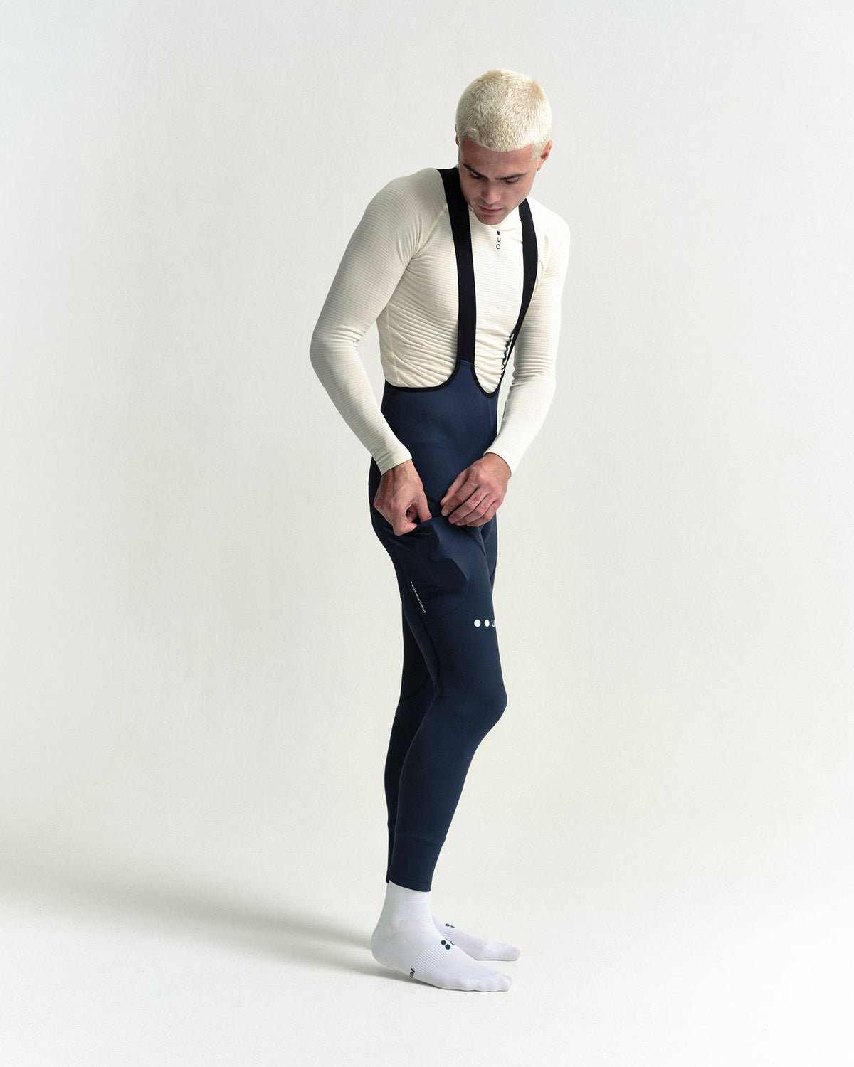 Model in the Men's Mono Cargo Bib Tight in Eclipse Navy, full-length view.