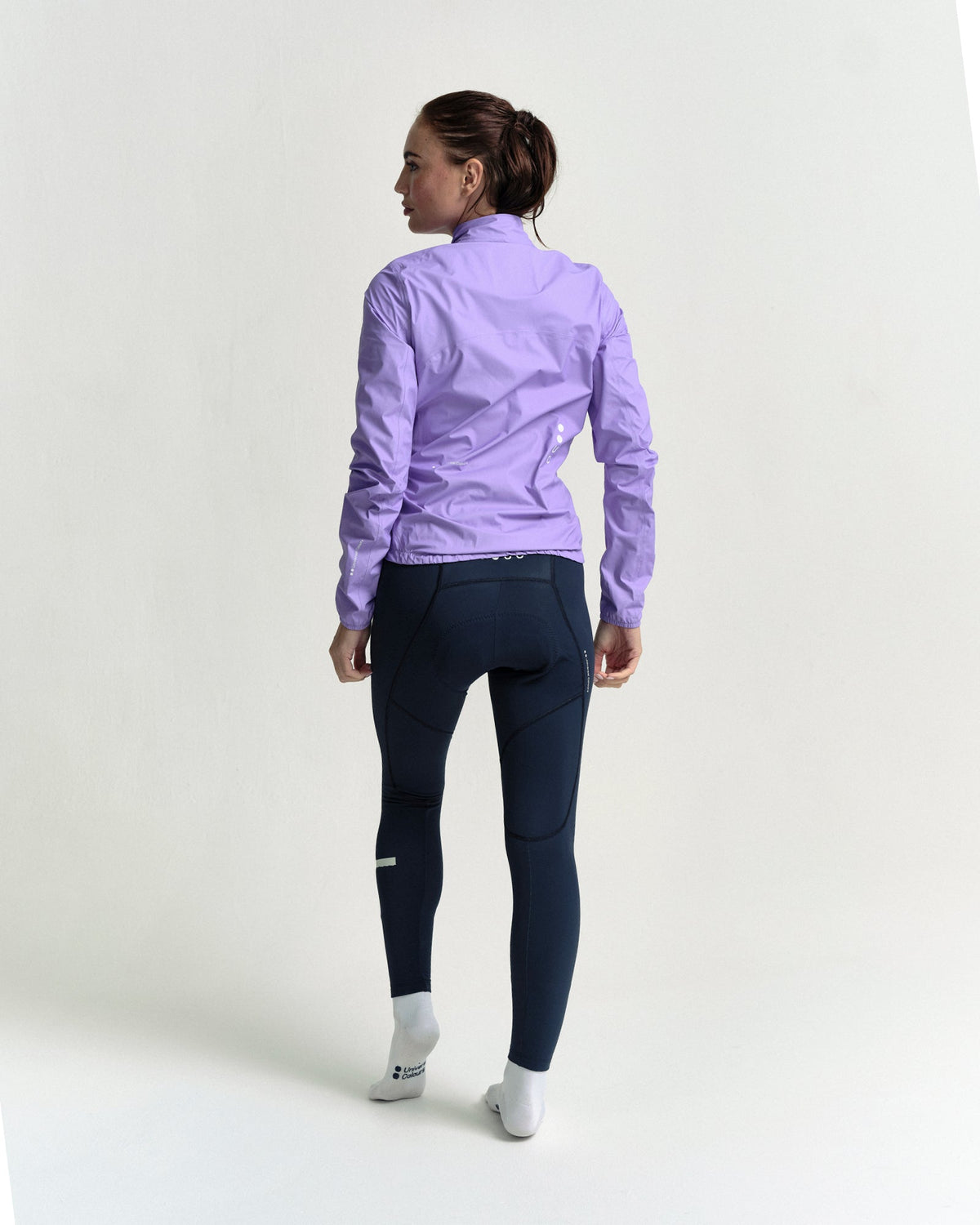 Model in the Women's Mono Rain Jacket in Cloud Lilac, full-length back view.