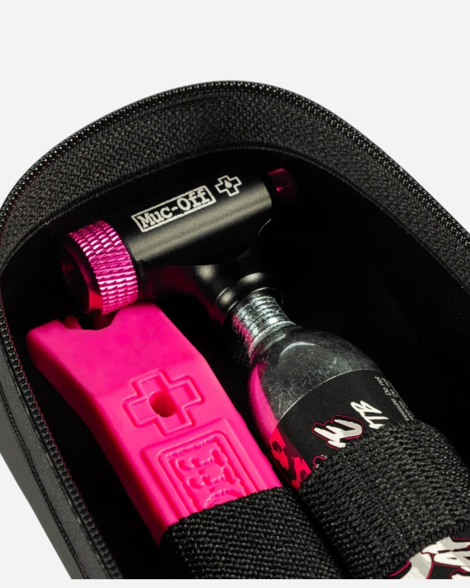 Moloko Cycling Ltd. small saddle pack interior with pink tyre lever, CO2 inflator, and repair tools in elastic straps
