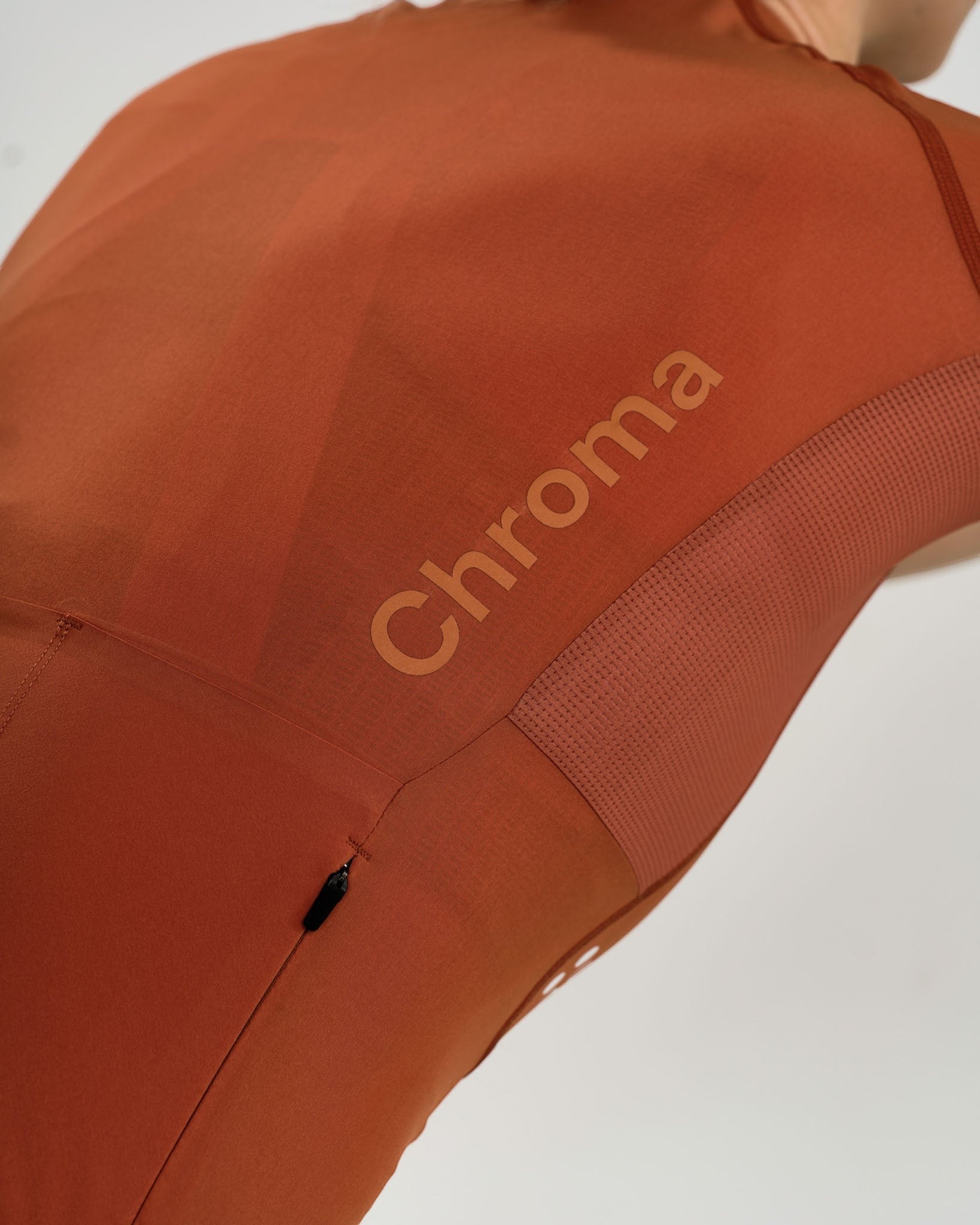 Moloko Cycling Ltd. women's short sleeve jersey in Cyprus Copper. Made from recycled polyester with a matte finish and three rear pockets.