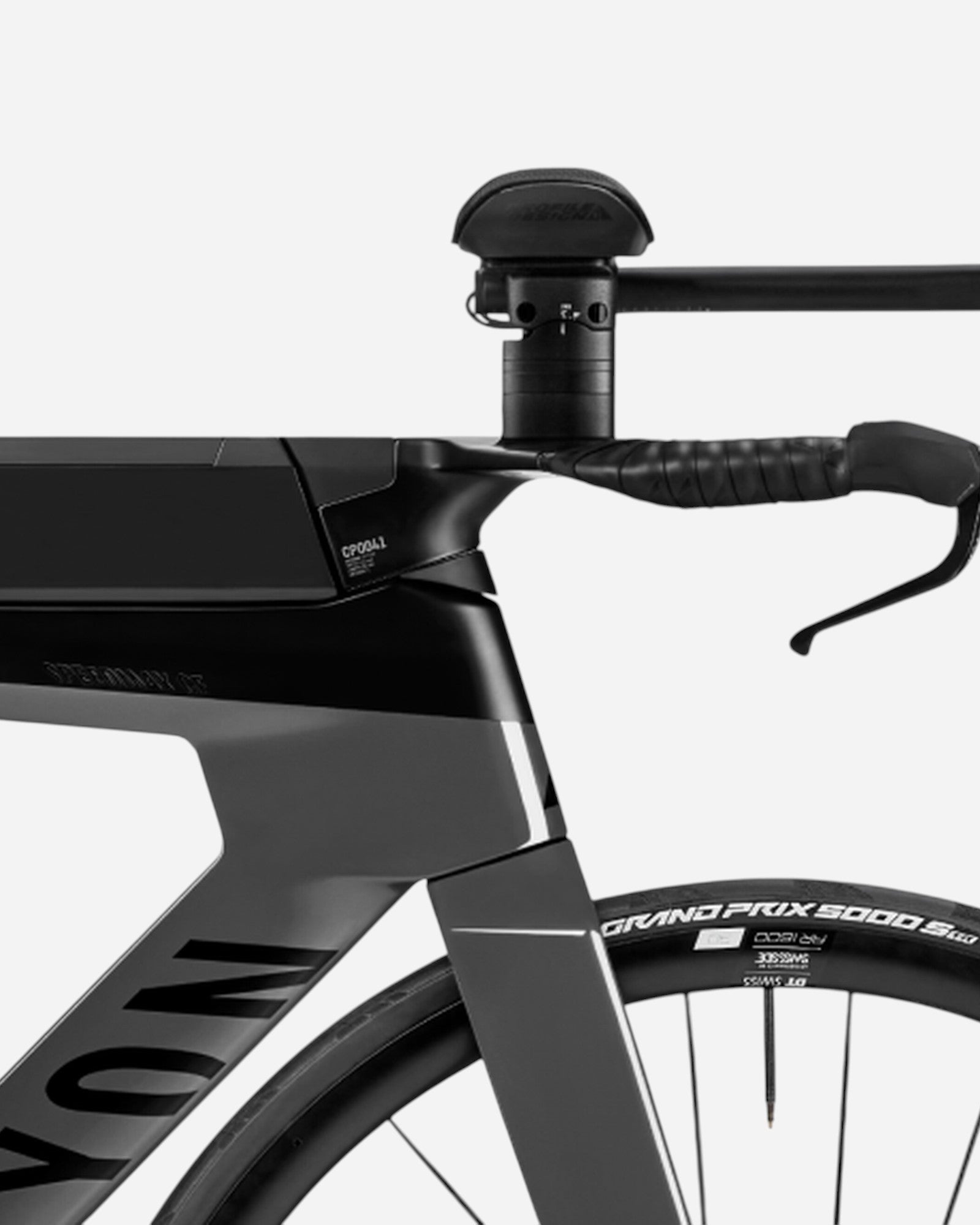 Moloko Cycling Ltd. Speedmax CF 7 triathlon bike, black and grey carbon frame, aerodynamic handlebars, integrated storage.