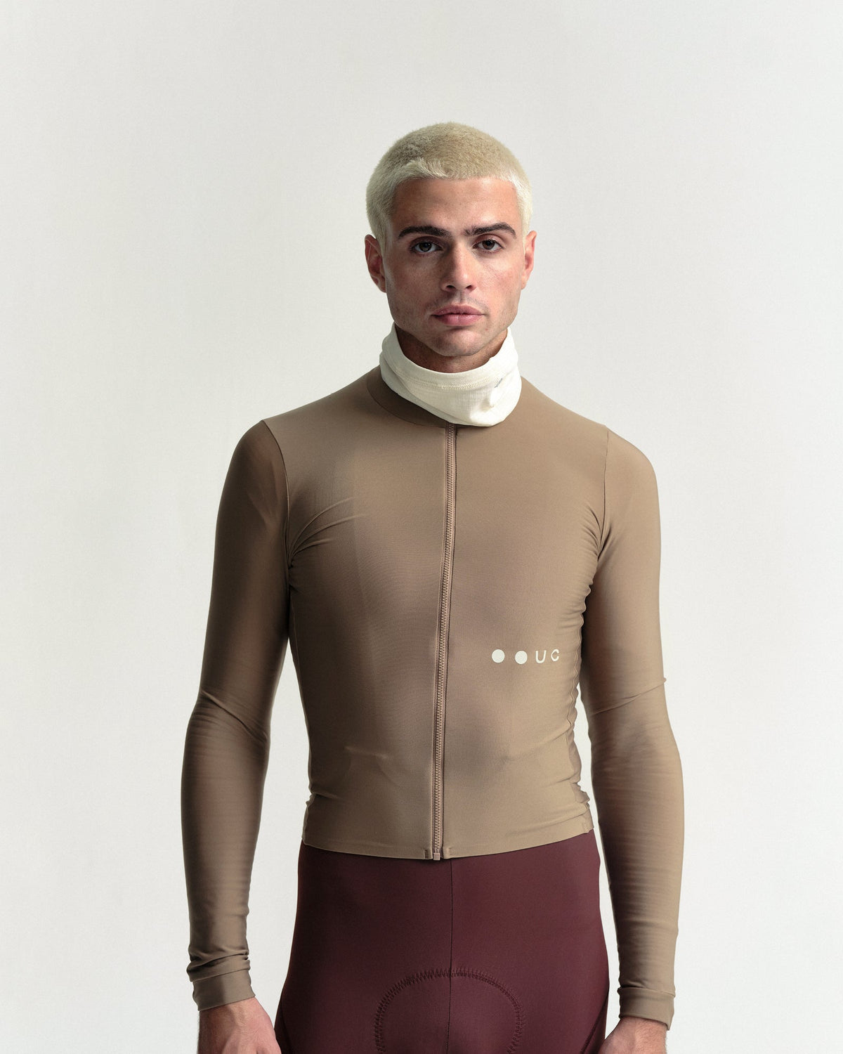 Model wearing the Polartec Neck Warmer in Off White.